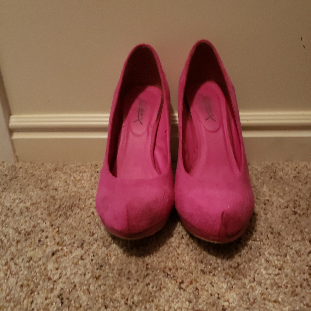 Bright pink suede high heel pumps